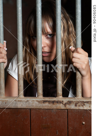 female rider locked in the stables behind bars female rider locked in the stables behind bars 90406085