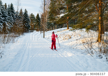 Small child in the ski track at winter forest in Finland. Small child in the ski track at winter forest in Finland. 90406337