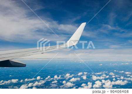 Plain wing over blue sky. Flight from Helsinki to Amsterdam. 90406408