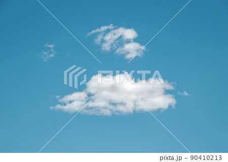 Blue summer sky with few sparse clouds, idyllic cloudscape with copy space 90410213