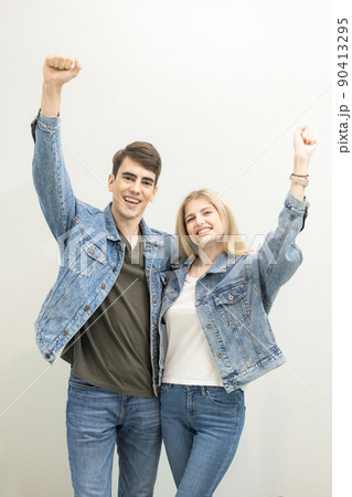 In the airport, a couple is awaiting boarding at lounge, people are waiting for their flights., a young joyful couple poses with their luggage. 90413295