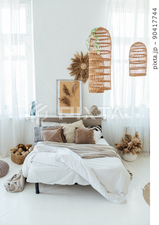 Comfortable bed with warm knitted plaid in stylish room interior 90417744