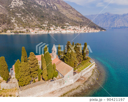 Aerophotography. View from flying drone. St George Island in the Bay of Kotor at Perast in Montenegro, with St George Benedictine Monastery. St. George Island, is a small natural island off the coast Aerophotography. View from flying drone. St George Island in the Bay of Kotor at Perast in Montenegro, with St George Benedictine Monastery. St. George Island, is a small natural island off the coast 90421197