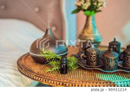 Aroma oil diffuser with aroma oil on table at home. Air freshener Aroma oil diffuser with aroma oil on table at home. Air freshener 90421214