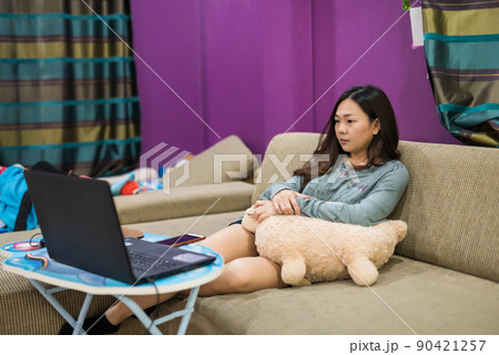 Asian woman on sofa watch stream online movie by laptop Asian woman on sofa watch stream online movie by laptop 90421257