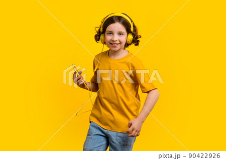 Girl dancing listening to music with headphones 90422926