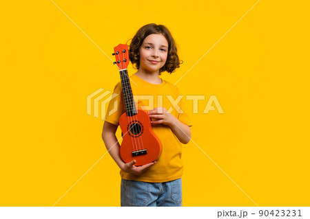Child girl with ukulele in studio Child girl with ukulele in studio 90423231