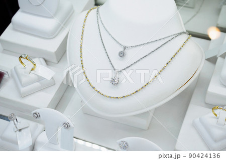 Jewelry diamond shop with rings and necklaces luxury retail store window display 90424136
