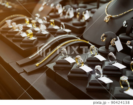 Gold jewelry diamond shop with rings and necklaces luxury retail store window display 90424138