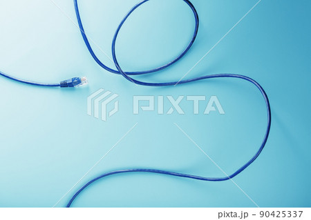 Blue Ethernet Cable Cord Patch cord on a blue background with free space 90425337