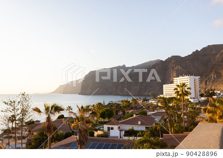 Landscape with cliff and houses near ocean.  90428896