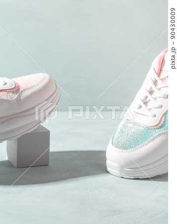 White pastel sneakers with sequins on geometric podiums on turquoise 90430009