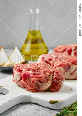 Closeup view at uncooked raw lamb loin chops saddle steaks 90430665