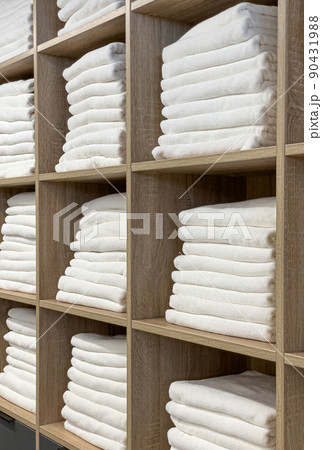The bathroom towel  on the shelves in the closet 90431988
