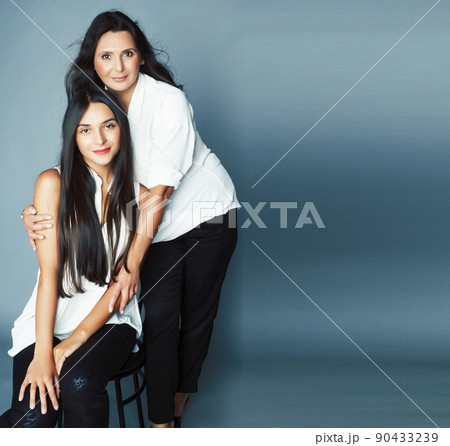 cute pretty teen daughter with mature mother hugging, fashion style brunette, lifestyle people concept close up cute pretty teen daughter with mature mother hugging, fashion style brunette, lifestyle people concept close up 90433239