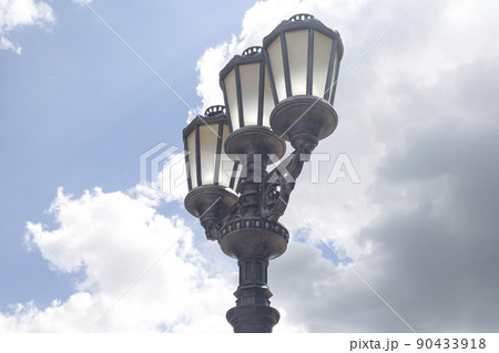 Old vintage street light against blue sky Old vintage street light against blue sky 90433918