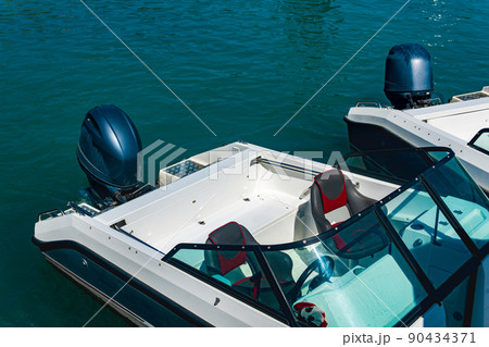 two moored motorboats with outboard motors two moored motorboats with outboard motors 90434371