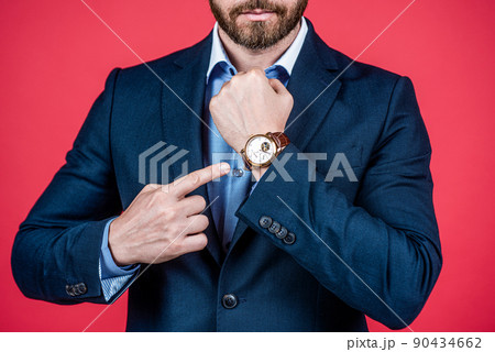 guy pointing finger on watch. business fashion style accessory. time is success. 90434662