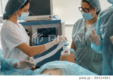 Well-trained anesthesiologist follows the patient during the surgery in clinic Well-trained anesthesiologist follows the patient during the surgery in clinic 90434963