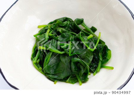 Boiled spinach on white background. 90434997