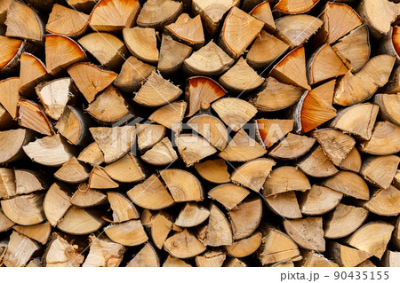 firewood stacked in the woodpile, textured firewood background of chopped wood firewood stacked in the woodpile, textured firewood background of chopped wood 90435155