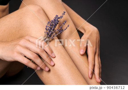 Female legs with derchitis hair in hand lavender flowers. Self love. Unshaven Female legs with derchitis hair in hand lavender flowers. Self love. Unshaven 90436712