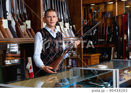 Owner of armory shop offering vintage hunting rifle Owner of armory shop offering vintage hunting rifle 90438265