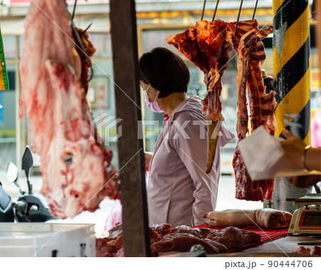 Fresh meat hanging at meat vendor in a Taipei market 90444706