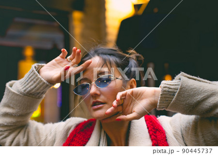 An attractive woman walks through a Japanese neighborhood in the city. Front view. An attractive woman walks through a Japanese neighborhood in the city. Front view. 90445737