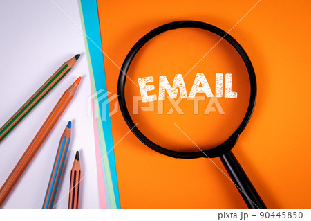 EMAIL. Magnifying glass on an orange background. Pencils on white EMAIL. Magnifying glass on an orange background. Pencils on white 90445850