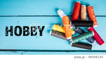 Hobby. Thread spools on a wooden background 90446145