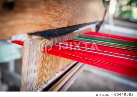 Thai and Asian Style Vintage textile thread machine to make traditional clothing and fabric pattern weaving. 90449082