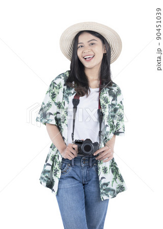 Asian woman with hat and camera standing 90451039