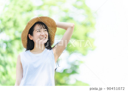 夏の旅行・レジャーに来た女性（新緑・笑顔） 90451072