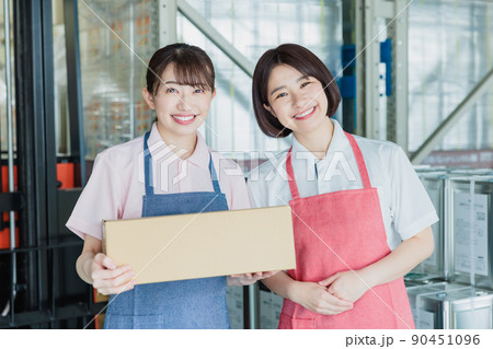 倉庫で明るく働く女性スタッフ 90451096