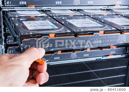 Cloud storage service, engineer pulling out panel and swapping hard drive disk hdd in server Cloud storage service, engineer pulling out panel and swapping hard drive disk hdd in server 90451600