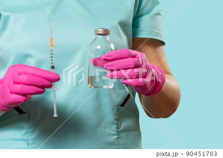 Plastic syringe and bottle for liquid medicine in hands. 90451703