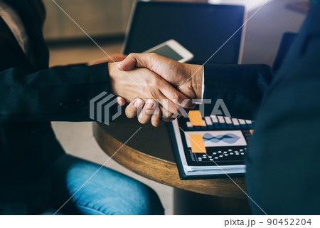 Businessmen shake hands to start a new project after consultation. 90452204