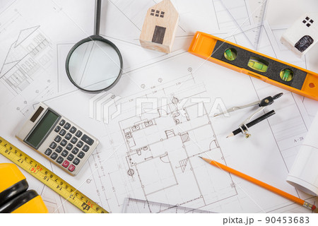 Top view of house plan blueprint paper with repair tools on table desk at architecture office 90453683