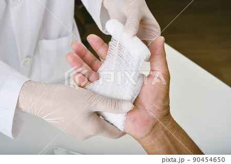 Doctor doing wound dressing care and bandaging patient's hand, Hand surgery treatment 90454650
