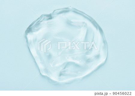 Clear cosmetic skincare gel with bubbles on blue background top view Clear cosmetic skincare gel with bubbles on blue background top view 90456022