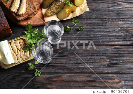 Flat lay composition with cold Russian vodka on black wooden table, space for text Flat lay composition with cold Russian vodka on black wooden table, space for text 90456702