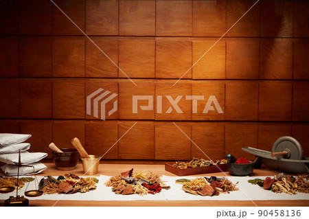 Traditional chinese medicine with herb in brown wooden background and medicine jar	 90458136