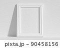 Vertical rectangular photo frame on floor leaning at wall 90458156