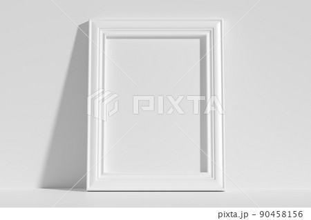 Vertical rectangular photo frame on floor leaning at wall 90458156