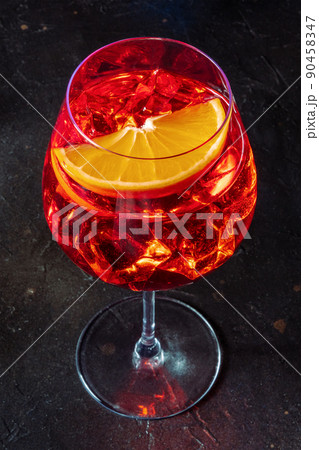 Aperol cocktail glass with an orange slice, Italian summer cold drink 90458347