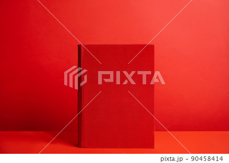 Hardcover book on red background. Space for design 90458414