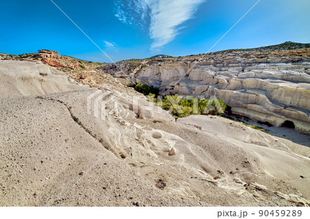 Famous white rocks of Sarakiniko beach, Aegean sea, Milos island , Greece. No people, empty cliffs, summer sunshine, blue sky and clouds 90459289