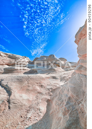 White rocks of Sarakiniko beach, Aegean sea, Milos island , Greece. No people, empty cliffs, summer sunshine, lunar landscape, deep blue sky, clouds White rocks of Sarakiniko beach, Aegean sea, Milos island , Greece. No people, empty cliffs, summer sunshine, lunar landscape, deep blue sky, clouds 90459296