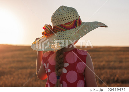 Child girl in straw hat dress in wheat field. Smiling kid in sunglasses sunset countryside. Cottagecore style aesthetic. Child girl in straw hat dress in wheat field. Smiling kid in sunglasses sunset countryside. Cottagecore style aesthetic. 90459475